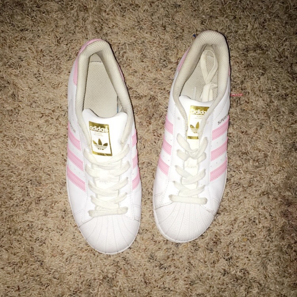 Pink and white super star adidas